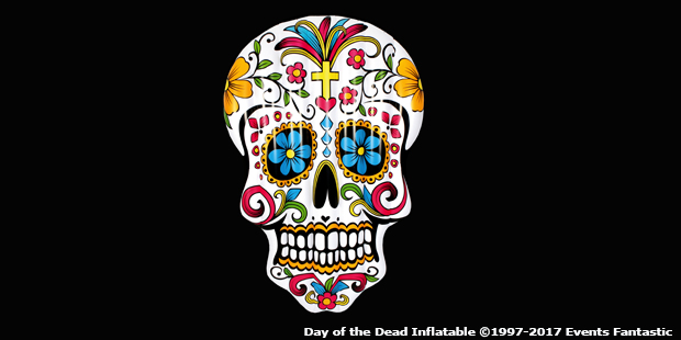 A colorful sugar skull with floral and decorative patterns, featuring a cross on the forehead, associated with the Day of the Dead.