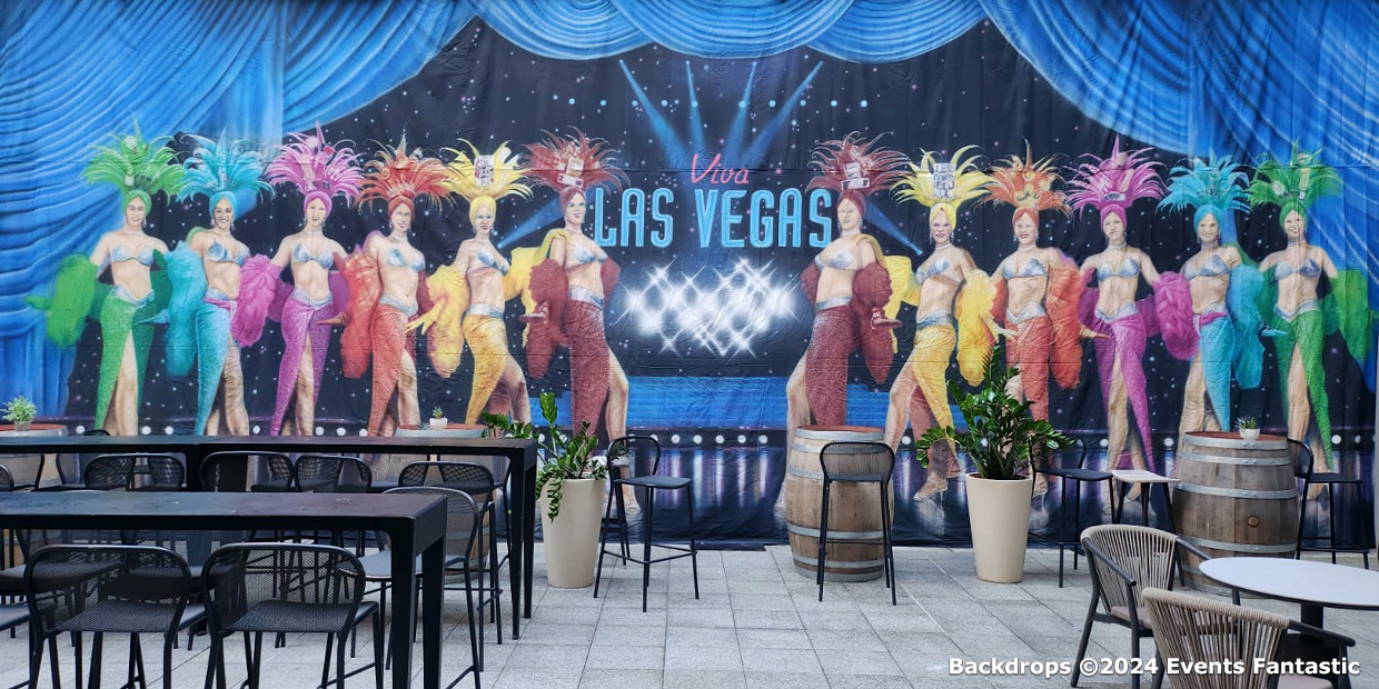 Colorful mural of Las Vegas showgirls in costumes and feathers with 
