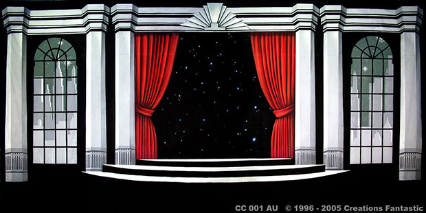 A stage set featuring a black starry background, flanked by white columns and large arched windows on either side, reminiscent of a Cabaret Club. Red curtains are drawn back, and white stairs lead up to the central area.