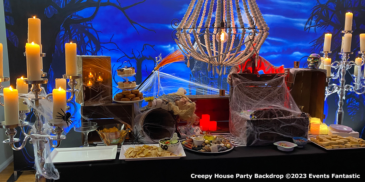 A creepy house party setup featuring tables adorned with snacks and decorations, including spider webs, skulls, candles, and a chandelier. The backdrop showcases a haunted house against a blue sky for an extra spine-tingling effect.