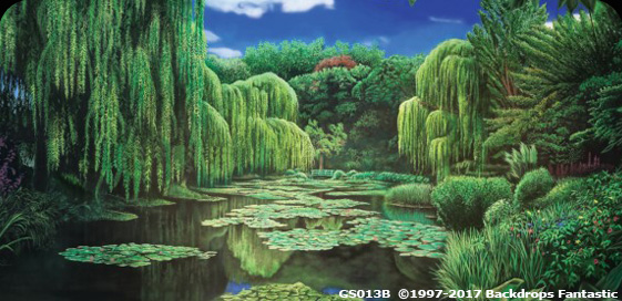 A lush, scenic landscape reminiscent of Monet's Garden features a pond with lily pads, surrounded by dense, weeping willow trees and various green shrubbery under a partly cloudy blue sky. Perfect as a serene party backdrop.