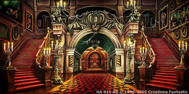 Elaborate interior of a grand haunted mansion featuring symmetrical red-carpeted staircases, ornate archways, statues, and chandeliers. Walls are adorned with various framed paintings.