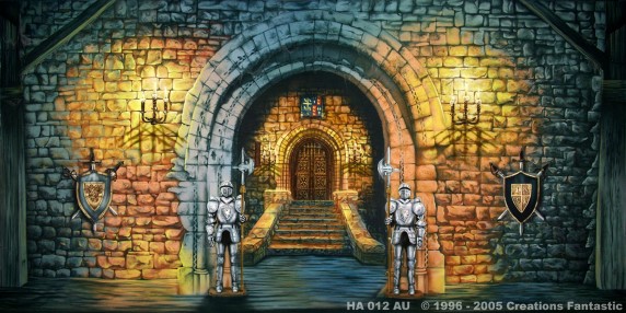 An arched stone entrance illuminated by wall sconces, with two suits of armor standing guard at either side, showcases impeccable castle design and leads to a staircase ascending to a grand wooden door.