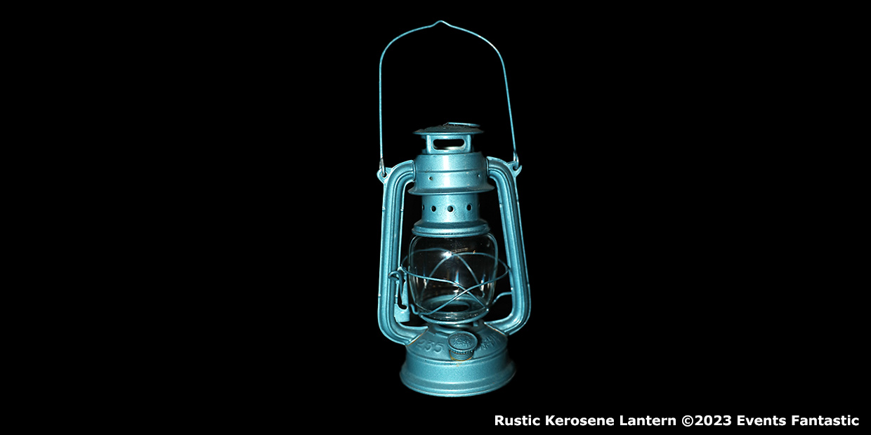 A blue rustic kerosene lantern with a wire handle and glass cover is displayed against a black background.