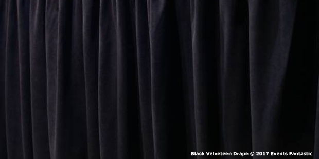 A black velveteen drape is shown hanging in vertical folds.