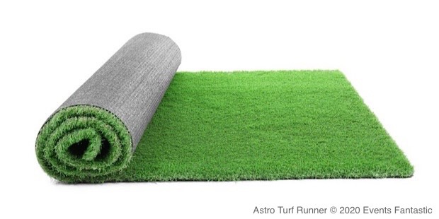 A roll of green Astro Turf partially unrolled on a white background.