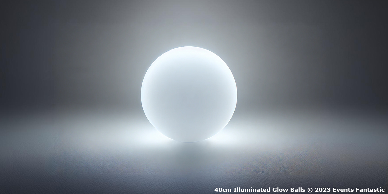 A glowing white sphere sits in the center of a dimly lit space, casting a soft halo of light. The text in the corner reads "40cm Orb Illuminated Glow Ball © 2023 Events Fantastic".