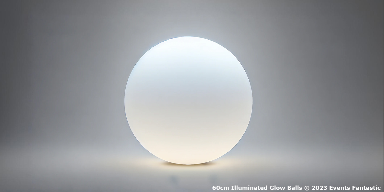 A 60cm illuminated glow ball orb in a minimally lit environment, casting a soft white light. Text at the bottom right reads, "60cm Illuminated Glow Balls © 2023 Events Fantastic".