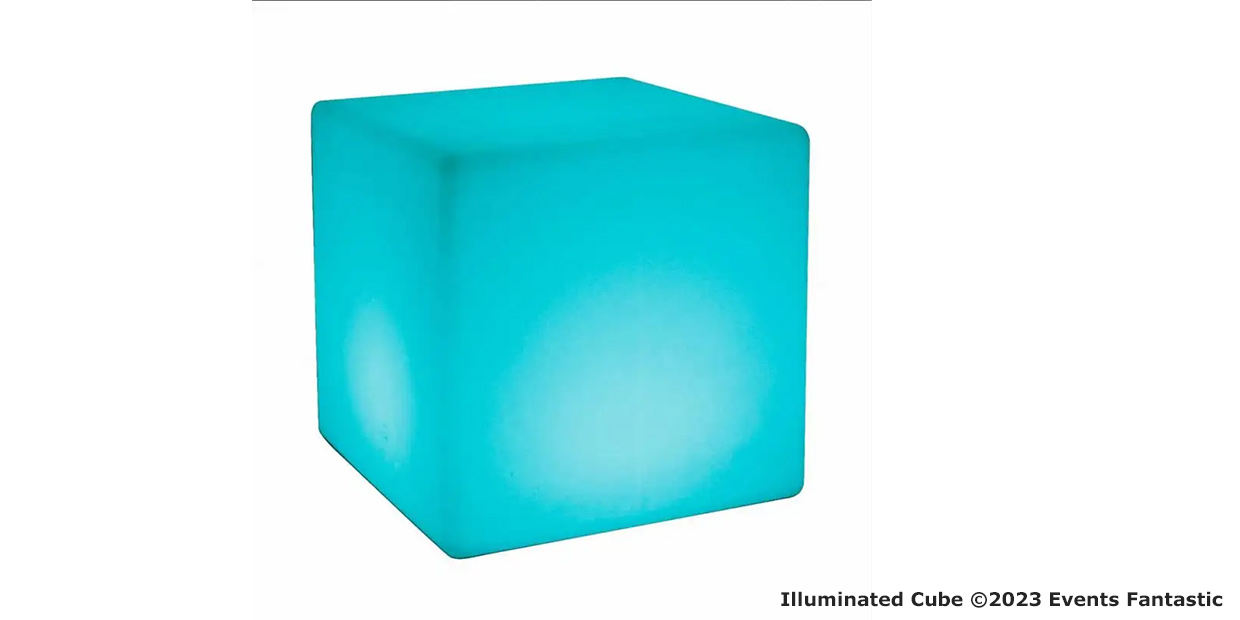 A glowing blue cube with a soft light. Text in the bottom right corner reads "Illuminated Cube ©2023 Events Fantastic". The gentle glow enhances its enchanting presence.