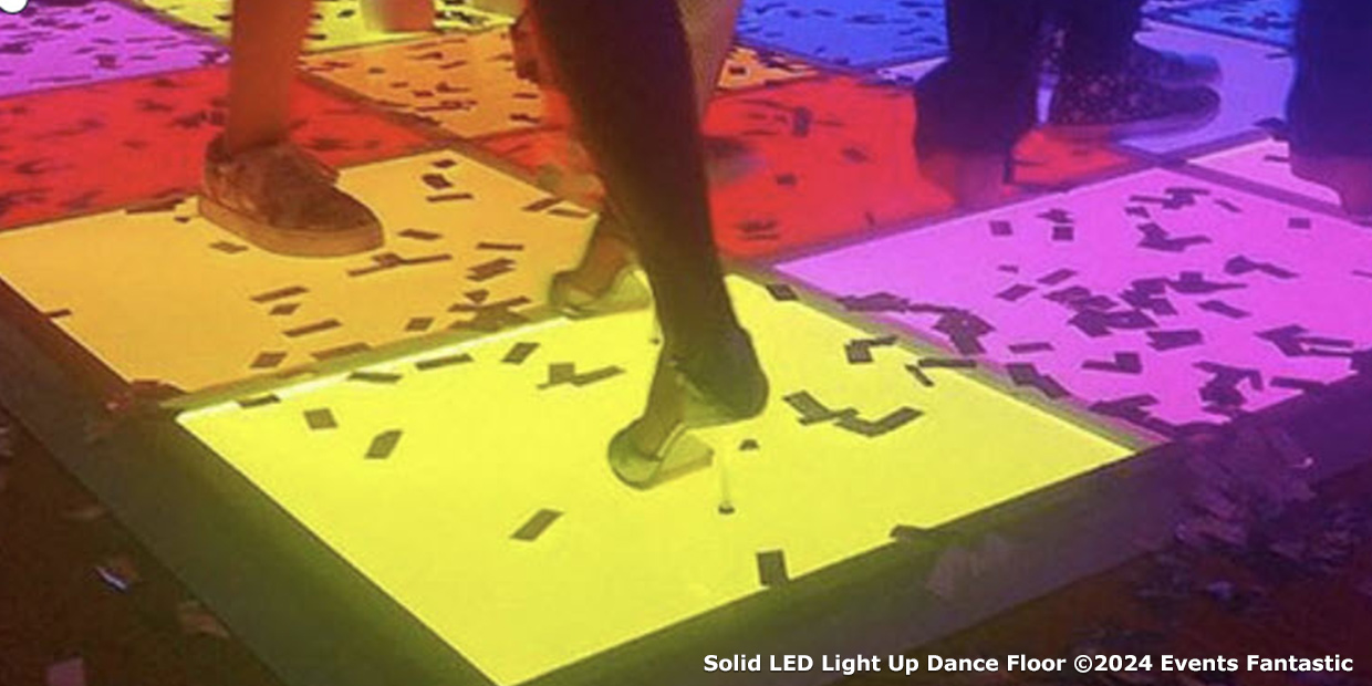 People dancing on a vibrant Colour LED Dance Floor with confetti scattered around.
