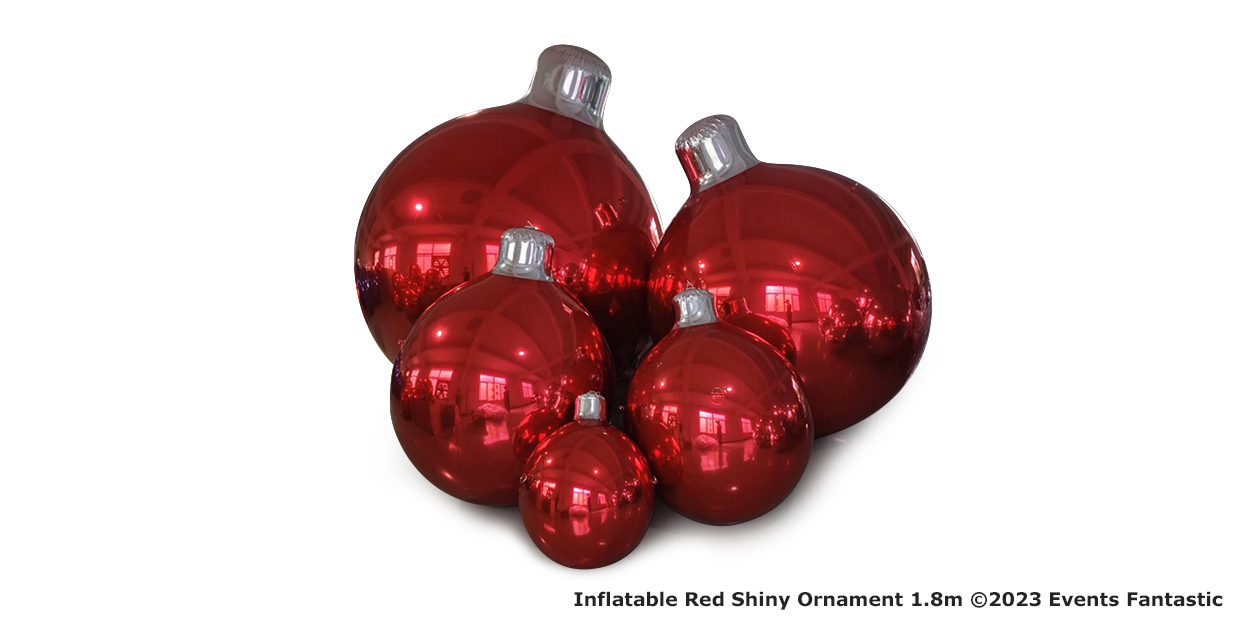 Four red shiny inflatable ornaments of different sizes are grouped together in this festive image. The text reads, "Inflatable Red Shiny Ornament 1.8m ©2023 Events Fantastic.