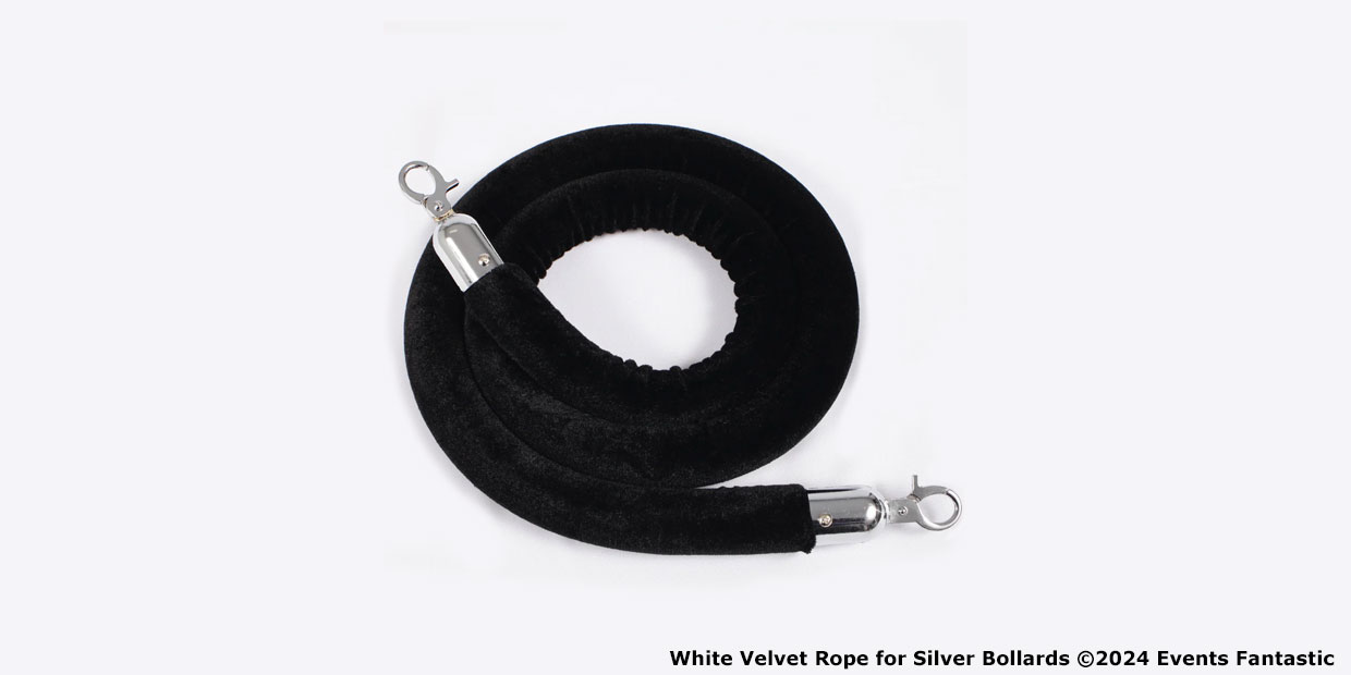 Coiled black velvet rope with silver hook ends for use with bollards, displayed against a white background.