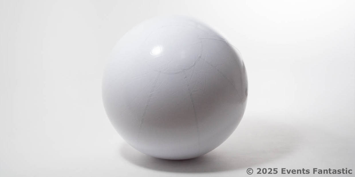 An Inflatable White Matt Ball, 1.2m in diameter, sits on a white surface with soft lighting and a faint shadow. The copyright © 2025 Events Fantastic is visible in the lower right corner.