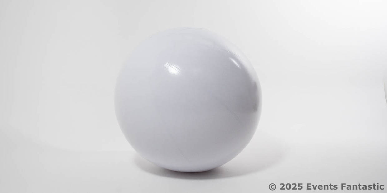 A plain, smooth White Matt Ball, 1m inflatable, sits on a white surface with a slight shadow; “© 2025 Events Fantastic” is printed in the lower right corner.
