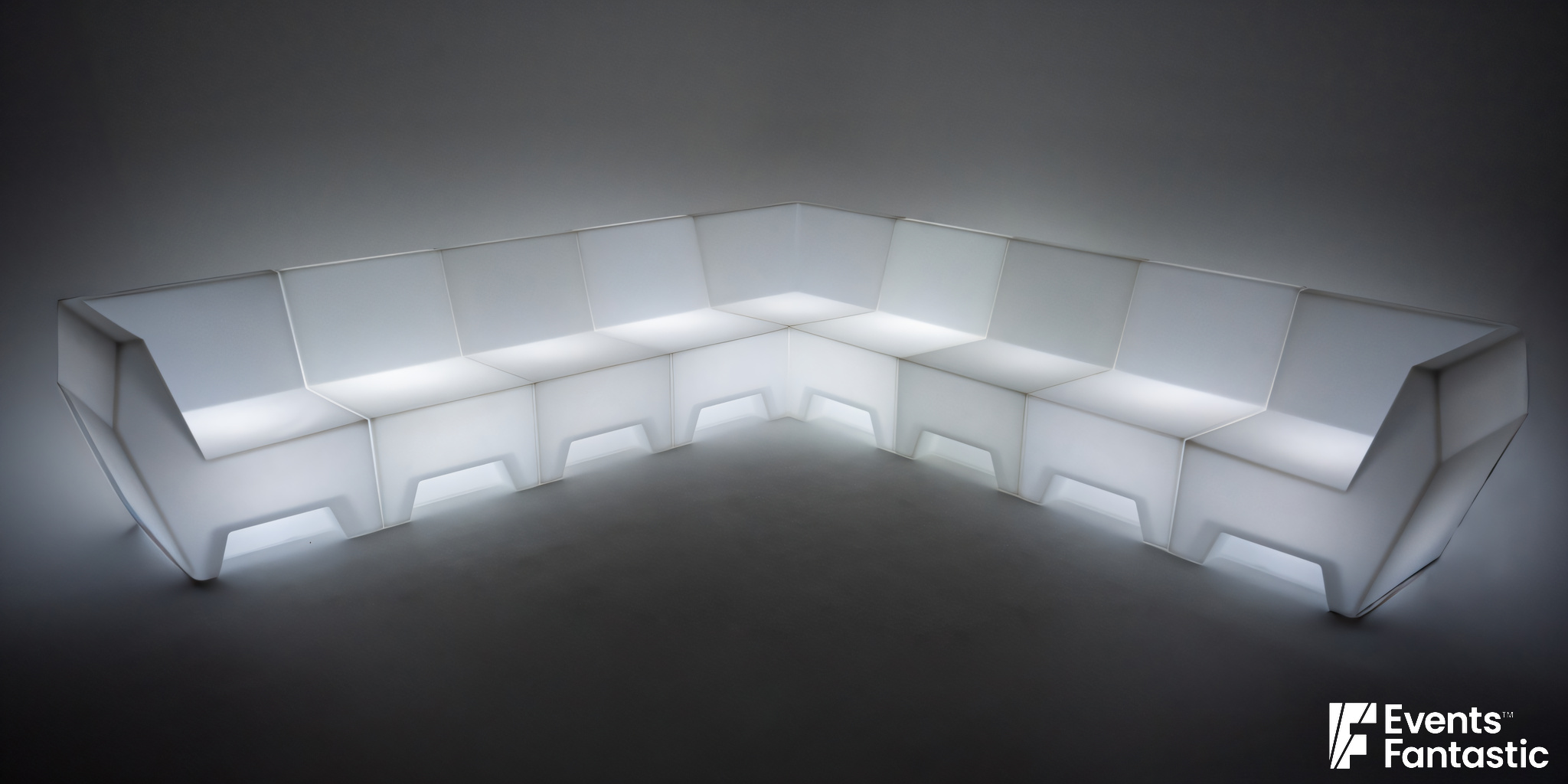 White, illuminated modular V Lounge corner sofa with an Illuminated Glow, set against a plain background. Features clean lines, modern design, and flexible 7 Piece configuration.