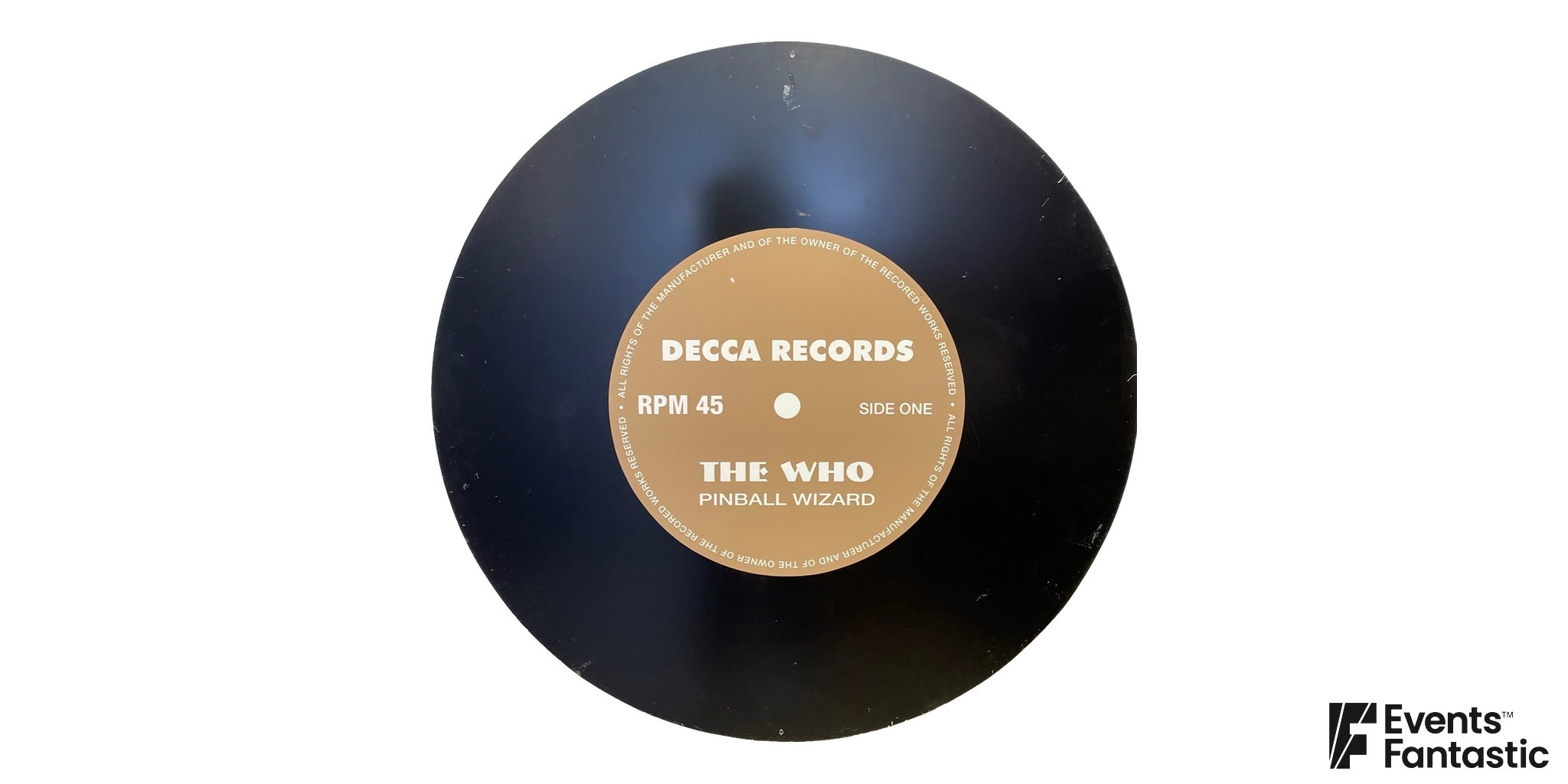 Black decorative record-shaped panel with a tan printed centre label.