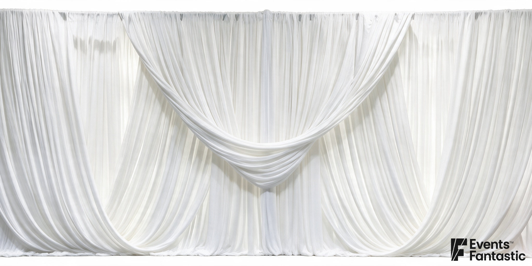 White draped backdrop with a central scalloped arrangement and gathered fabric below.