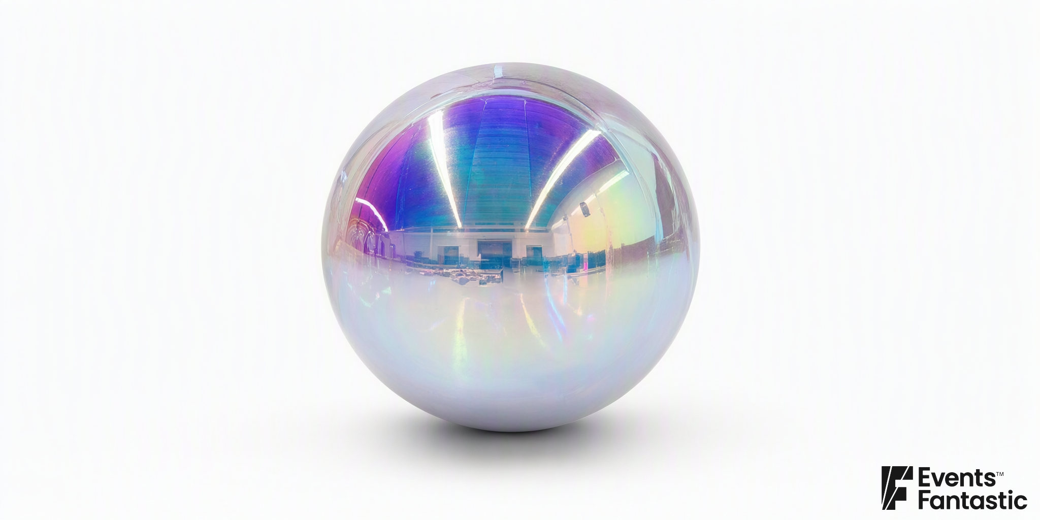 Inflatable iridescent shiny ball, a 1.8m mirror sphere with a violet, teal and gold rainbow sheen, available to hire.